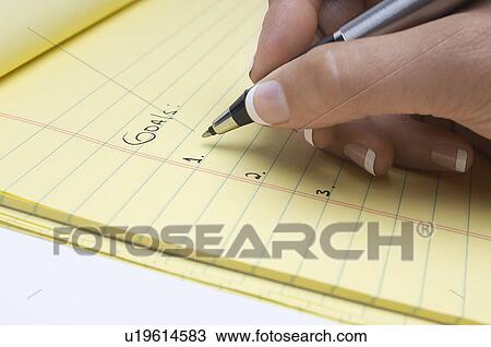 Woman writing list of goals, close-up of hand View Large Photo Image Stock Image - Woman writing list of goals, close-up of hand. Fotosearch