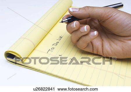 Stock Image - Woman writing list of tasks to do, close-up of hand. Fotosearch