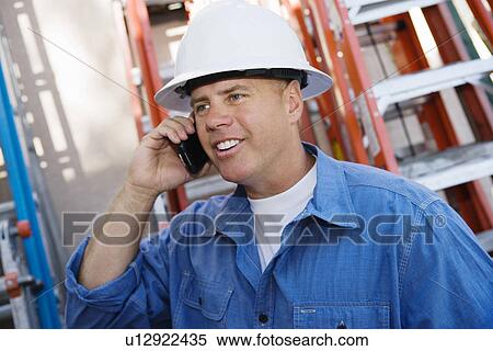 Worker Talking on Cell Phone View Large Photo Image Stock Photography - Worker Talking on Cell Phone. Fotosearch