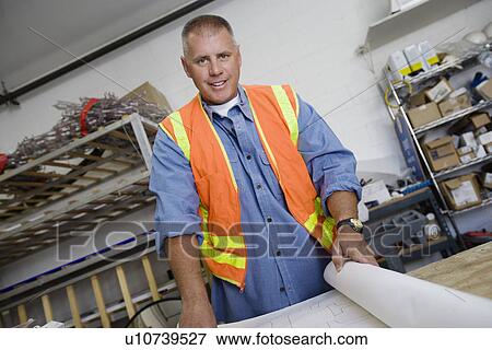Workman Checking Building Plans View Large Photo Image Stock Photo - Workman Checking Building Plans. Fotosearch