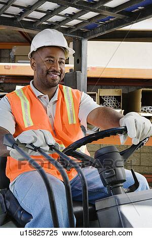 Stock Photography - Workman Driving a Forklift. Fotosearch