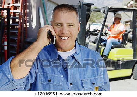 Workman Talking on a Cell Phone View Large Photo Image Stock Image - Workman Talking on a Cell Phone. Fotosearch