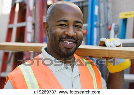 Workman with a Two-by-Four View Large Photo Image Stock Photo - Workman with a Two-by-Four. Fotosearch