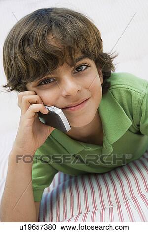 Stock Image - Young Boy Using Cell Phone. Fotosearch