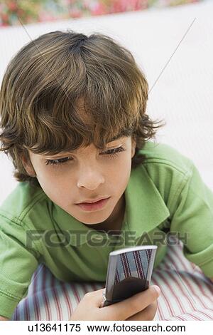 Young Boy Using Cell Phone View Large Photo Image Stock Photography - Young Boy Using Cell Phone. Fotosearch