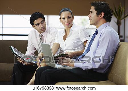 Stock Photo - Young business people working in office. Fotosearch