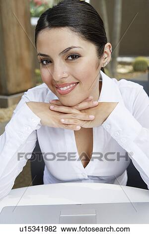 Stock Image - Young business woman smiling, portrait. Fotosearch