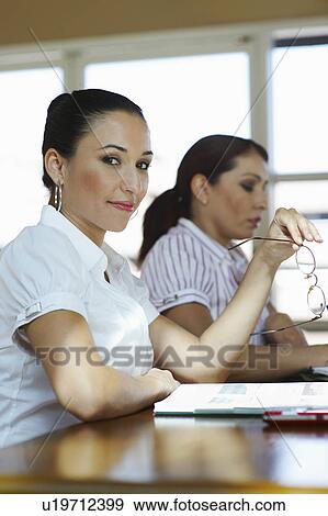 Young business women in office View Large Photo Image Stock Photo - Young business women in office. Fotosearch