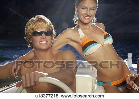 Young couple embracing in boat on lake, portrait View Large Photo Image Stock Photo - Young couple embracing in boat on lake, portrait. Fotosearch