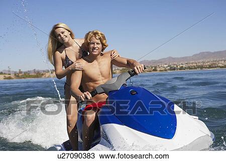 Young couple riding jetski on lake, portrait View Large Photo Image Stock Image - Young couple riding jetski on lake, portrait. Fotosearch