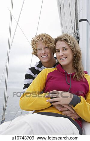 Young couple smiling on sailboat, portrait View Large Photo Image Stock Photo - Young couple smiling on sailboat, portrait. Fotosearch