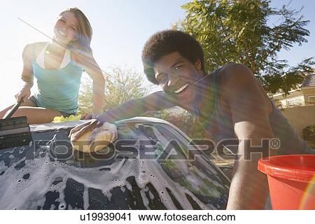 Young couple washing car outdoors, portrait View Large Photo Image Stock Image - Young couple washing car outdoors, portrait. Fotosearch