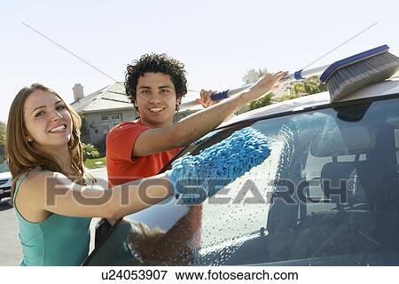 Stock Photo - Young couple washing car. Fotosearch