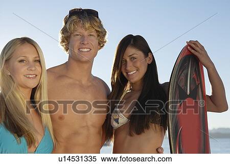 Stock Photography - Young friends in swimwear outdoors, portrait. Fotosearch