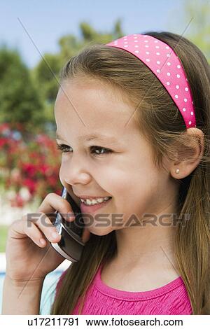 Stock Image - Young Girl Using Cell Phone. Fotosearch
