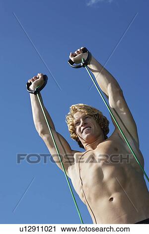 Stock Image - Young man exercising outdoors. Fotosearch