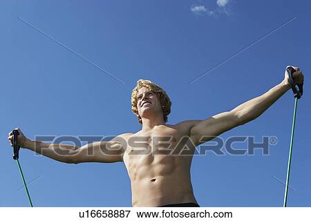 Young man exercising outdoors View Large Photo Image Stock Photo - Young man exercising outdoors. Fotosearch