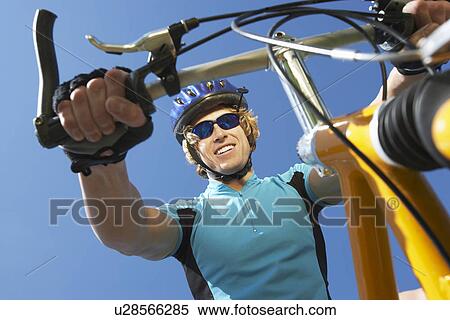 Stock Photography - Young man on bicycle outdoors. Fotosearch