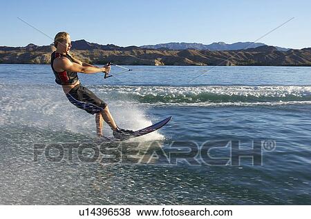 Young man wakeboarding on lake View Large Photo Image Stock Photo - Young man wakeboarding on lake. Fotosearch