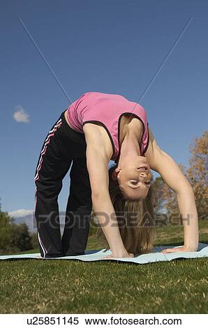 Young woman exercising in park View Large Photo Image Stock Photography - Young woman exercising in park. Fotosearch