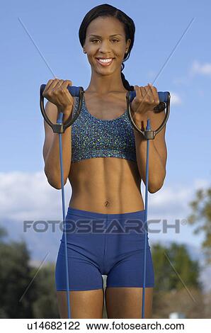 Stock Image - Young woman exercising outdoors, portrait. Fotosearch
