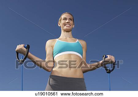 Young woman exercising outdoors View Large Photo Image Stock Image - Young woman exercising outdoors. Fotosearch