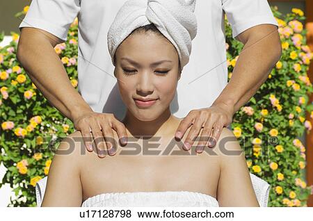 Young woman having shoulder massage at health spa View Large Photo Image Stock Photo - Young woman having shoulder massage at health spa. Fotosearch