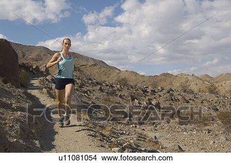 Young woman jogging in mountains View Large Photo Image Picture - Young woman jogging in mountains. Fotosearch