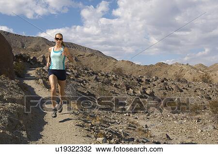 Young woman jogging in mountains View Large Photo Image Stock Image - Young woman jogging in mountains. Fotosearch