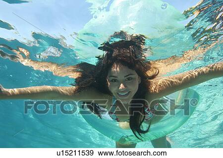 Young woman swimming in pool, underwater view View Large Photo Image Stock Photo - Young woman swimming in pool, underwater view. Fotosearch