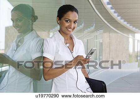 Stock Image - Young Woman Talking on a Cell Phone. Fotosearch