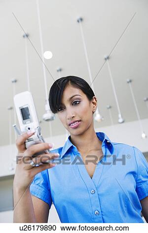 Stock Image - Young Woman Using Cell Phone. Fotosearch