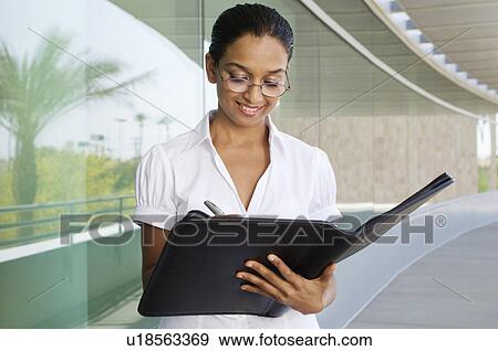 Young Woman Writing in a Planner View Large Photo Image Stock Photo - Young Woman Writing in a Planner. Fotosearch