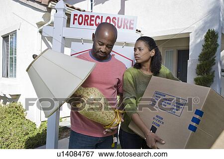 Bankrupt couple moving out of house View Large Photo Image Stock Photo - Bankrupt couple moving out of house. Fotosearch