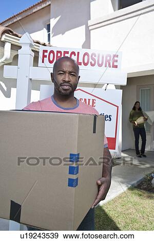 Bankrupt couple moving out of house View Large Photo Image Stock Photo - Bankrupt couple moving out of house. Fotosearch