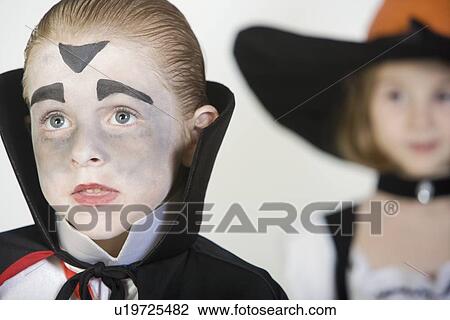 Boy (7-9), wearing dracula costume, girl in background View Large Photo Image Stock Image - Boy (7-9), wearing dracula costume, girl in background. Fotosearch