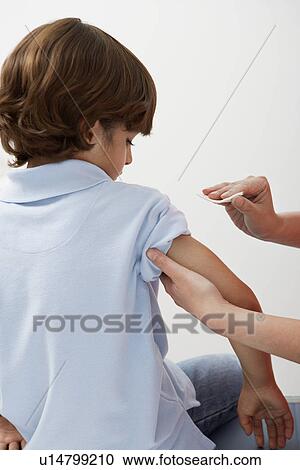 Boy being prepared to receive injection View Large Photo Image Stock Image - Boy being prepared to receive injection. Fotosearch