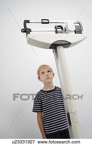 Stock Photo - Boy being weighted. Fotosearch