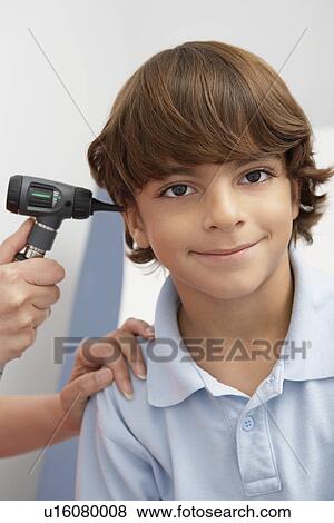 Boy having his ear examined View Large Photo Image Stock Photo - Boy having his ear examined. Fotosearch