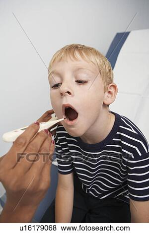 Boy having his temperature taken View Large Photo Image Stock Photo - Boy having his temperature taken. Fotosearch
