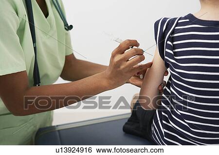 Boy receiving injection, close-up View Large Photo Image Stock Photograph - Boy receiving injection, close-up. Fotosearch