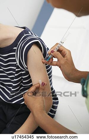 Boy receiving injection View Large Photo Image Stock Photography - Boy receiving injection. Fotosearch