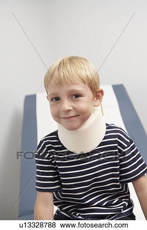 Stock Photo - Boy wearing neck brace in hospital, portrait. Fotosearch