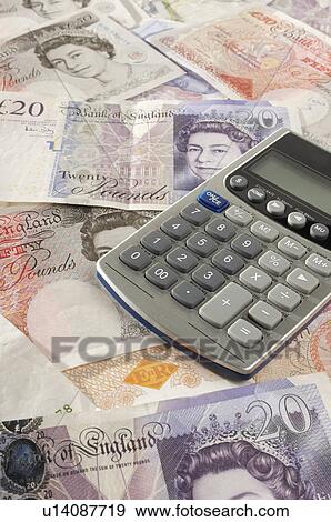 Stock Photo - British paper currency and calculator. Fotosearch