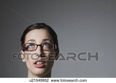 Brunette with blue eyes and spectacles looking up View Large Photo Image Stock Image - Brunette with blue eyes and spectacles looking up. Fotosearch