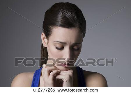 Brunette with head tilted down View Large Photo Image Stock Photography - Brunette with head tilted down. Fotosearch