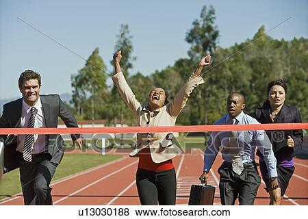 Stock Photo - Business People Crossing the Winning Line. Fotosearch