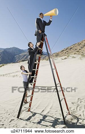 Business People on Stepladder Using Megaphone in Desert View Large Photo Image Picture - Business People on Stepladder Using Megaphone in Desert. Fotosearch