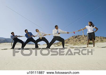 Business People Playing Tug of war in the Desert View Large Photo Image Stock Photo - Business People Playing Tug of war in the Desert. Fotosearch