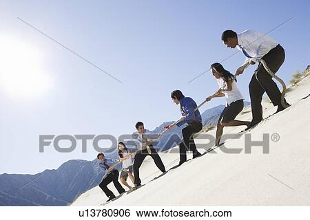 Business People Playing Tug of war in the Desert View Large Photo Image Stock Photograph - Business People Playing Tug of war in the Desert. Fotosearch